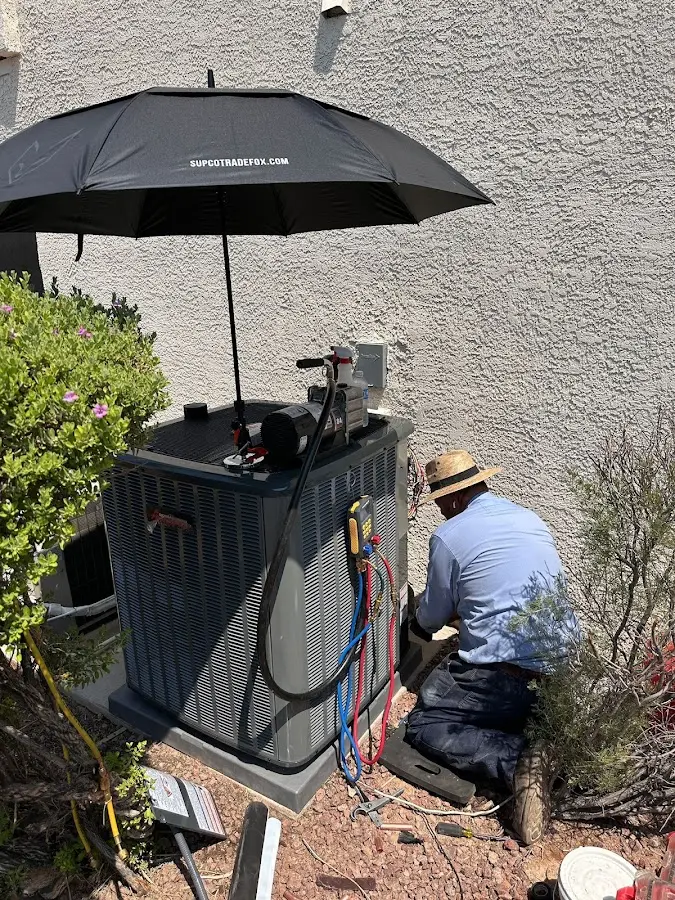 HVAC technician performing outdoor AC maintenance in Shreveport
