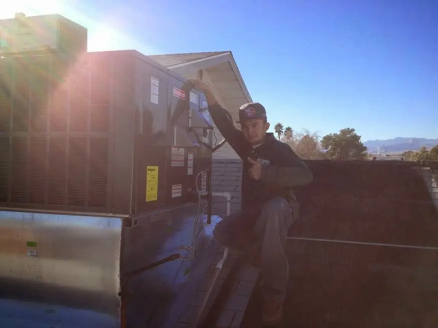 HVAC technician performing HVAC Inspection on a rooftop unit in Shreveport